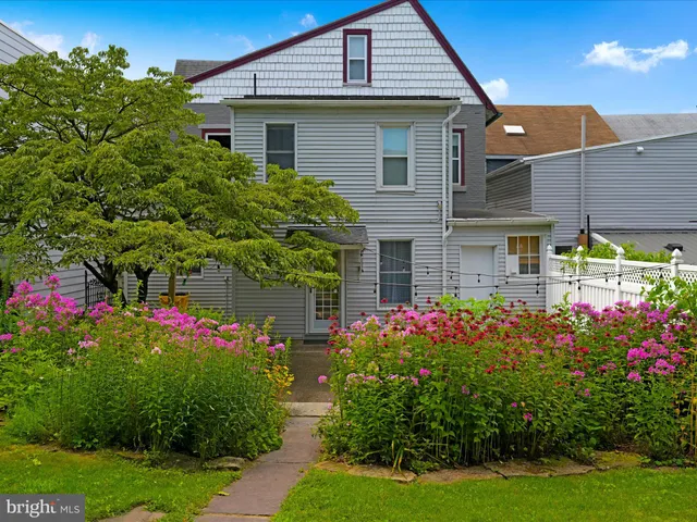 a view of a house with a flower garden