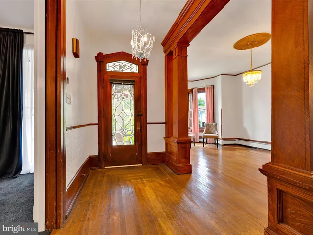 a view of a room with wooden floor and windows