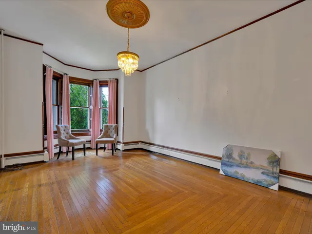 a view of a room with gym equipment and large windows