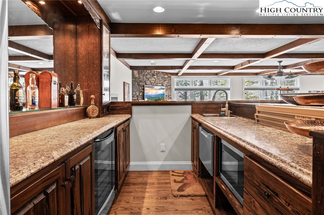 123 St Andrews Road Beech Mountain, NC 28604 - Photo 23 of 50 a kitchen with stainless steel appliances granite countertop a sink and wooden cabinets