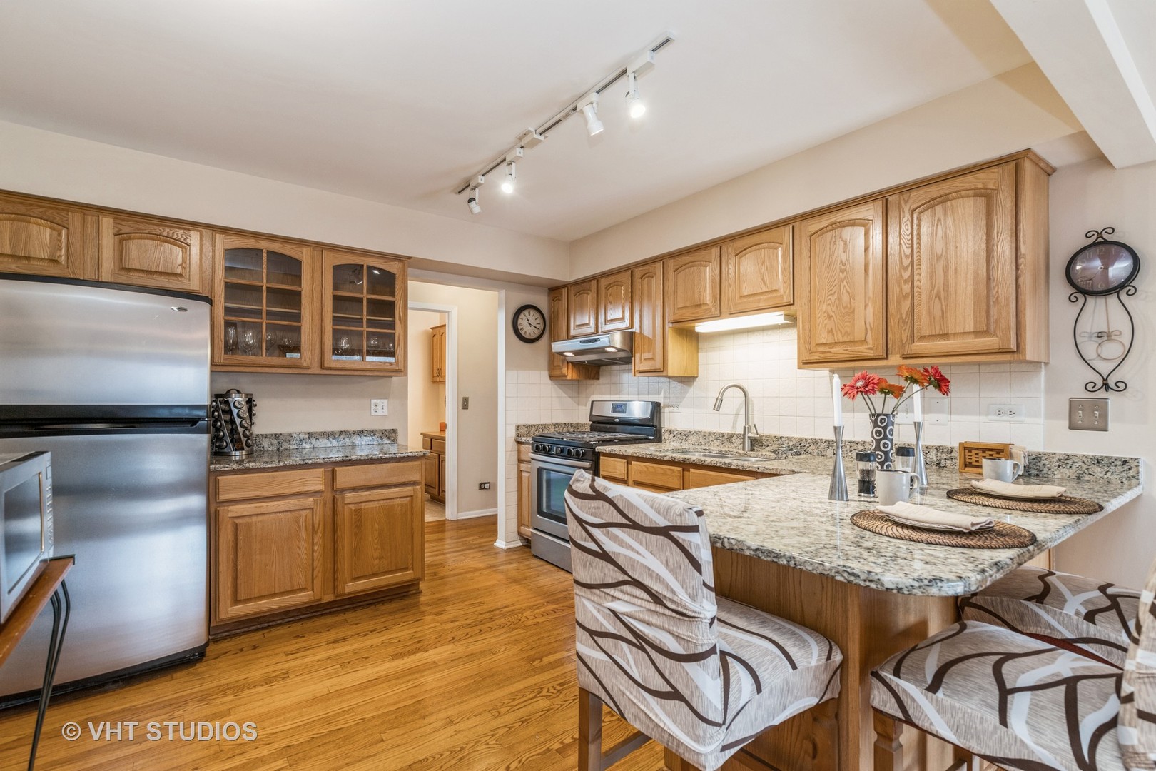 873 Barlina Road Crystal Lake, IL 60014 - Photo 10 of 24 a kitchen with granite countertop kitchen island stainless steel appliances a stove refrigerator sink and cabinets