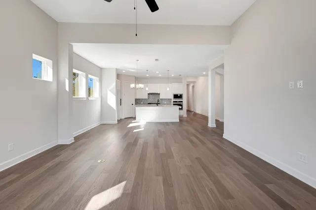 a view of a living room hardwood floor and a kitchen