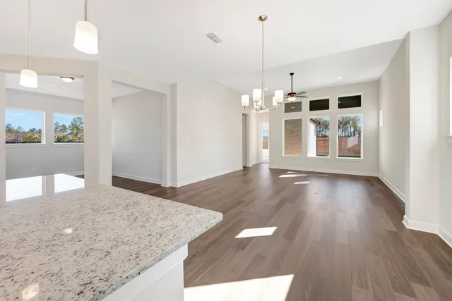 a view of a kitchen with wooden floor and windows