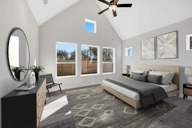 a bedroom with a bed a couch and a large window