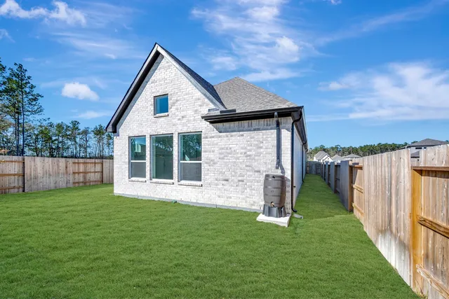 a view of a house with a yard and pathway