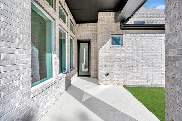 a view of a brick house with a large windows