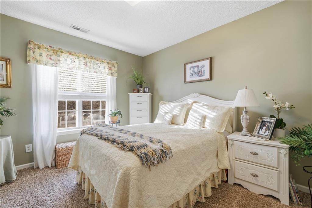 291 Buck Boulevard Southeast Calhoun, GA 30701 - Photo 13 of 32 a bedroom with a bed and a window