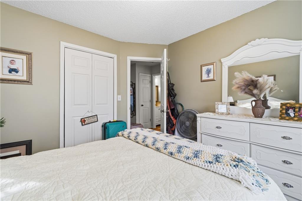 291 Buck Boulevard Southeast Calhoun, GA 30701 - Photo 14 of 32 a bedroom with a bed and a dresser