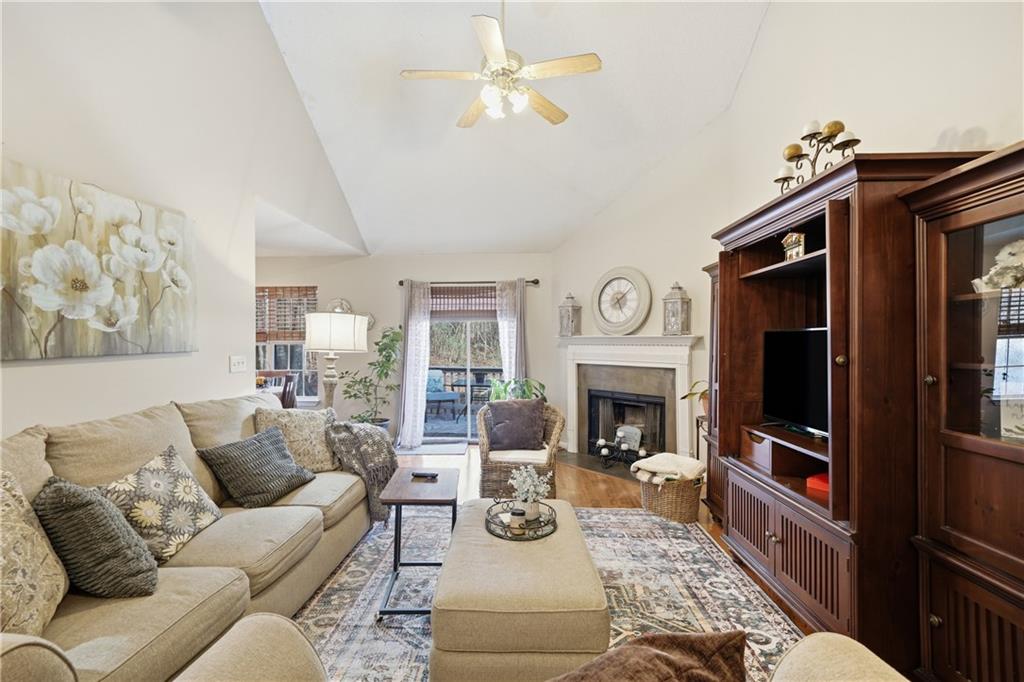 291 Buck Boulevard Southeast Calhoun, GA 30701 - Photo 17 of 32 a living room with furniture a fireplace and a flat screen tv