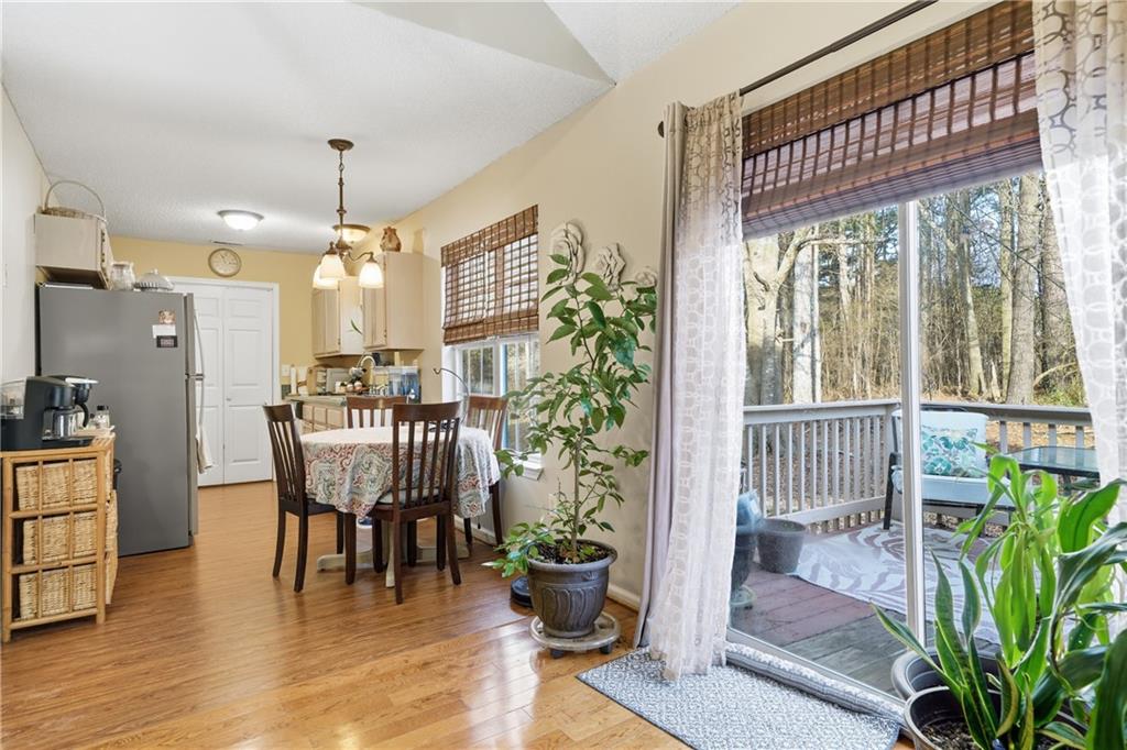 291 Buck Boulevard Southeast Calhoun, GA 30701 - Photo 20 of 32 a dining room with furniture potted plants and wooden floor
