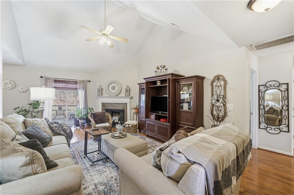 291 Buck Boulevard Southeast Calhoun, GA 30701 - Photo 2 of 32 a living room with furniture a clock and a chandelier