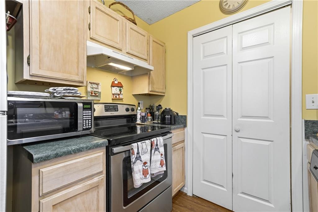 291 Buck Boulevard Southeast Calhoun, GA 30701 - Photo 23 of 32 a kitchen with stainless steel appliances granite countertop a stove and a microwave