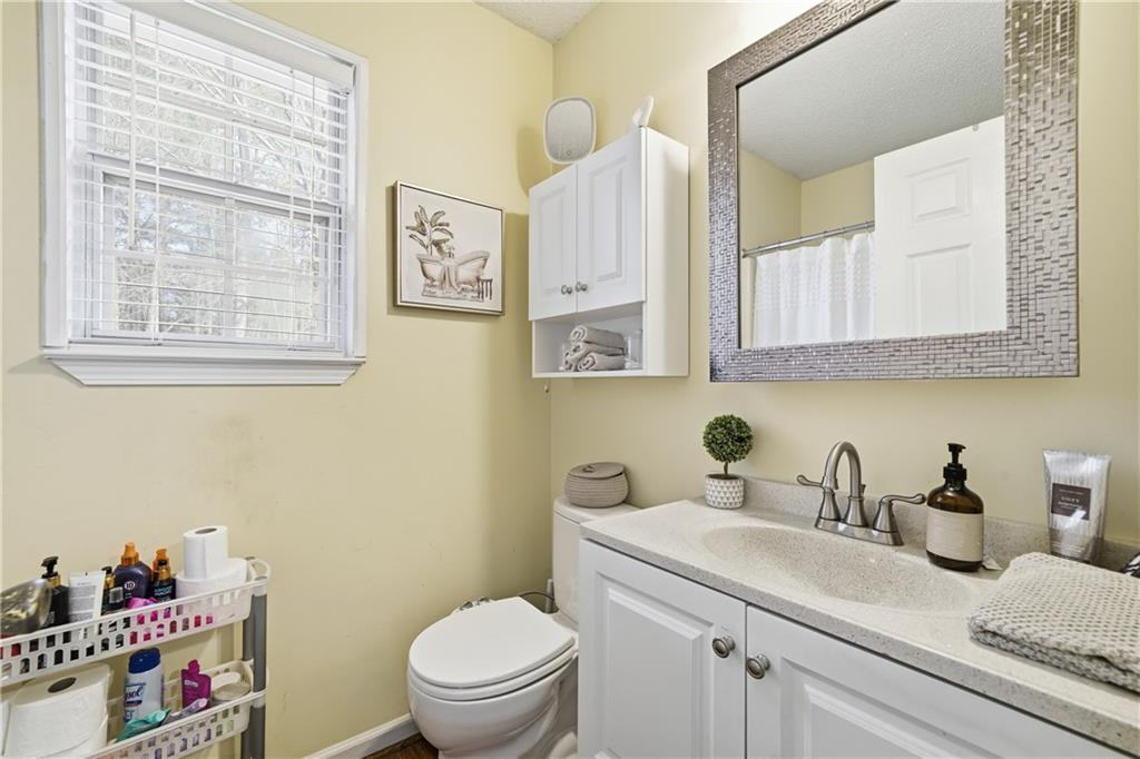 291 Buck Boulevard Southeast Calhoun, GA 30701 - Photo 9 of 32 a bathroom with a sink a toilet and a mirror