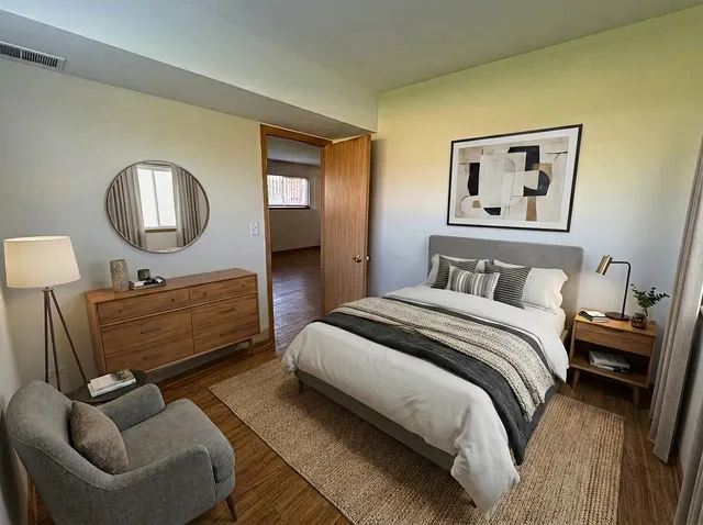 a bedroom with a bed couch and window