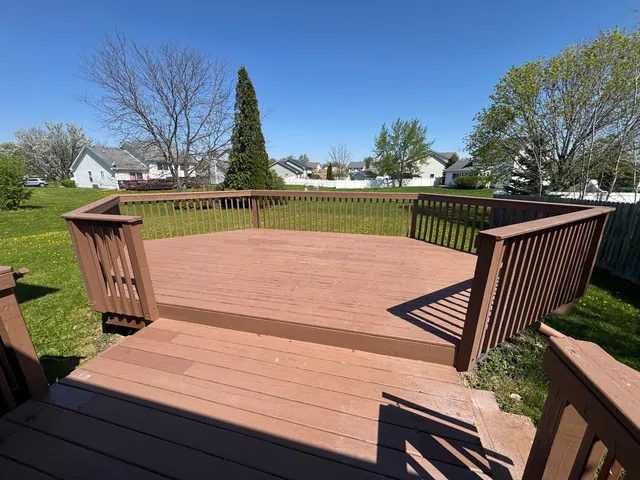 a view of a wooden deck with lake view
