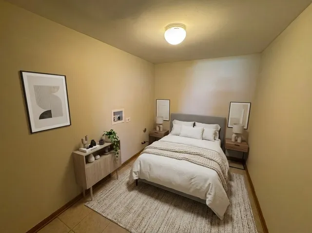 a bed room with a bed and a night stand