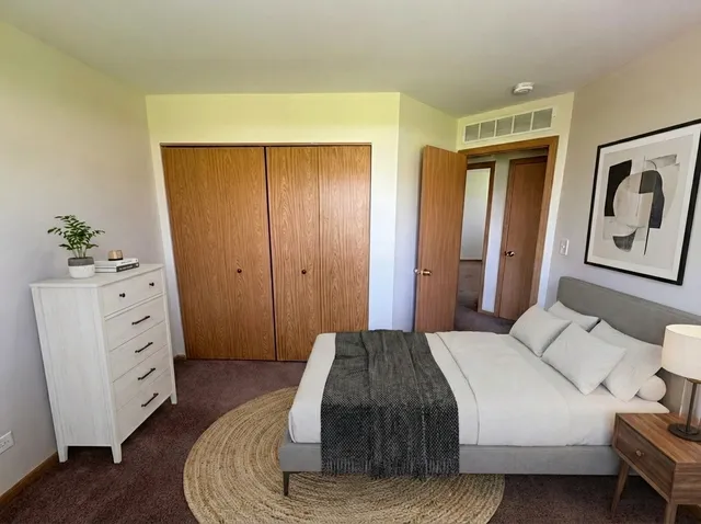 a bedroom with a bed and a dresser