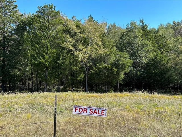 a street sign that is on a brick wall