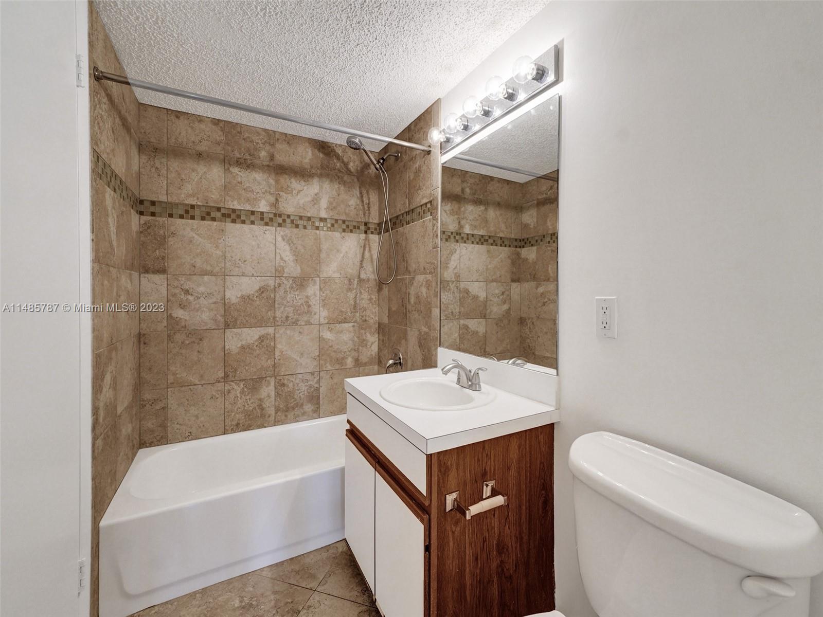 6339 La Costa Drive, Unit C Boca Raton, FL 33433 - Photo 15 of 23 a bathroom with a sink a toilet and shower
