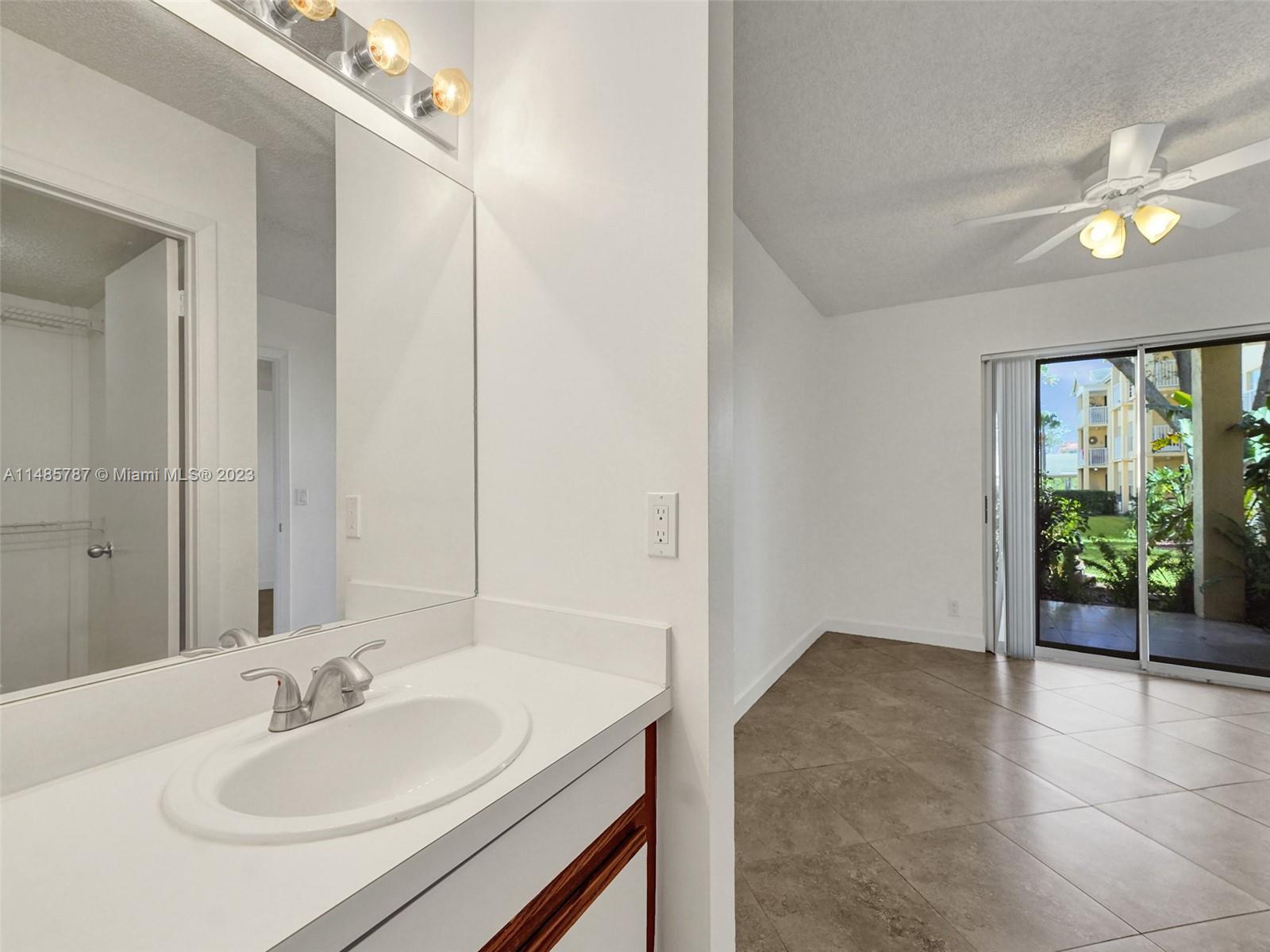 6339 La Costa Drive, Unit C Boca Raton, FL 33433 - Photo 16 of 23 a bathroom with a sink and a mirror