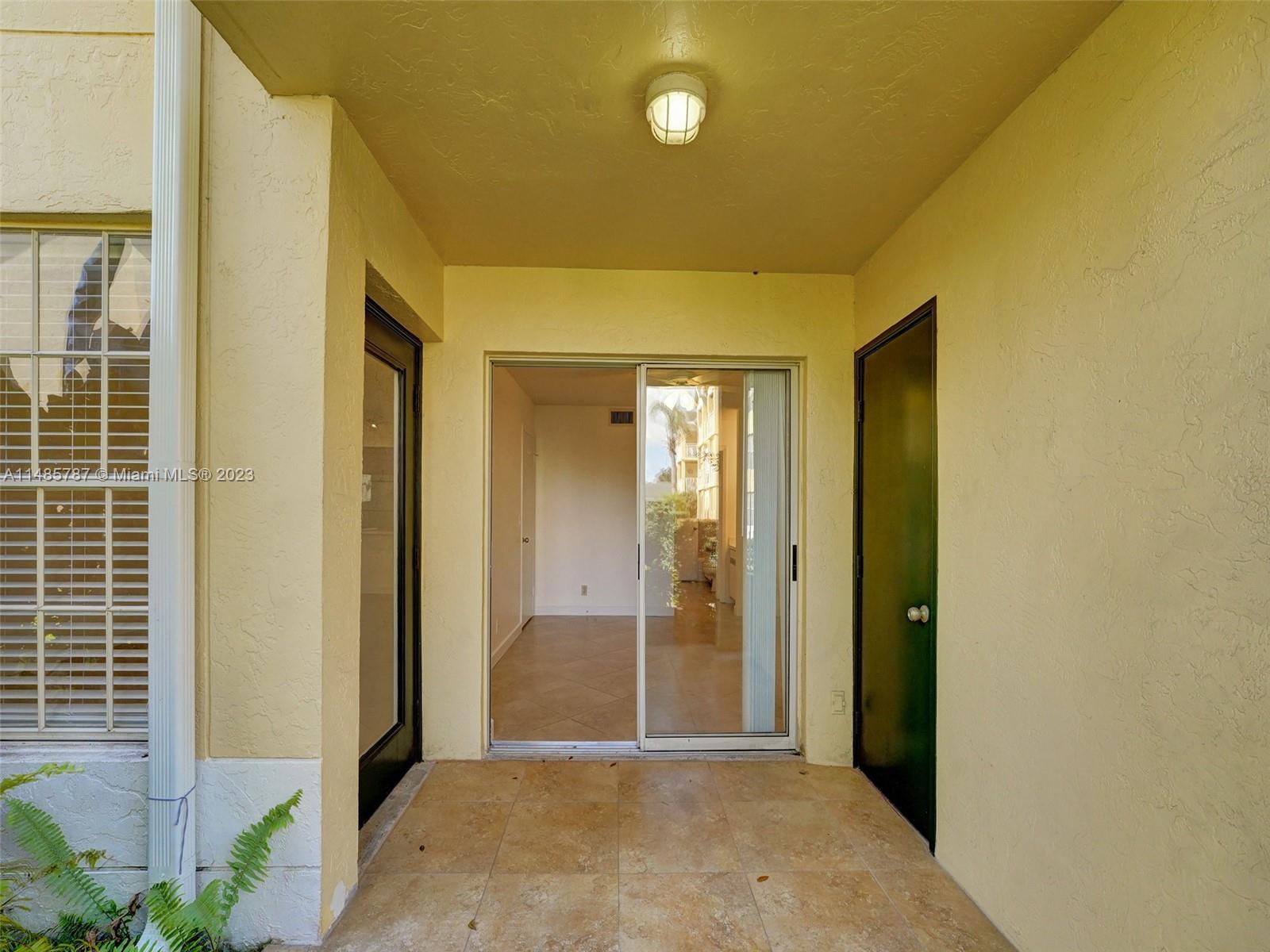 6339 La Costa Drive, Unit C Boca Raton, FL 33433 - Photo 20 of 23 a view of a hallway with wooden shelves