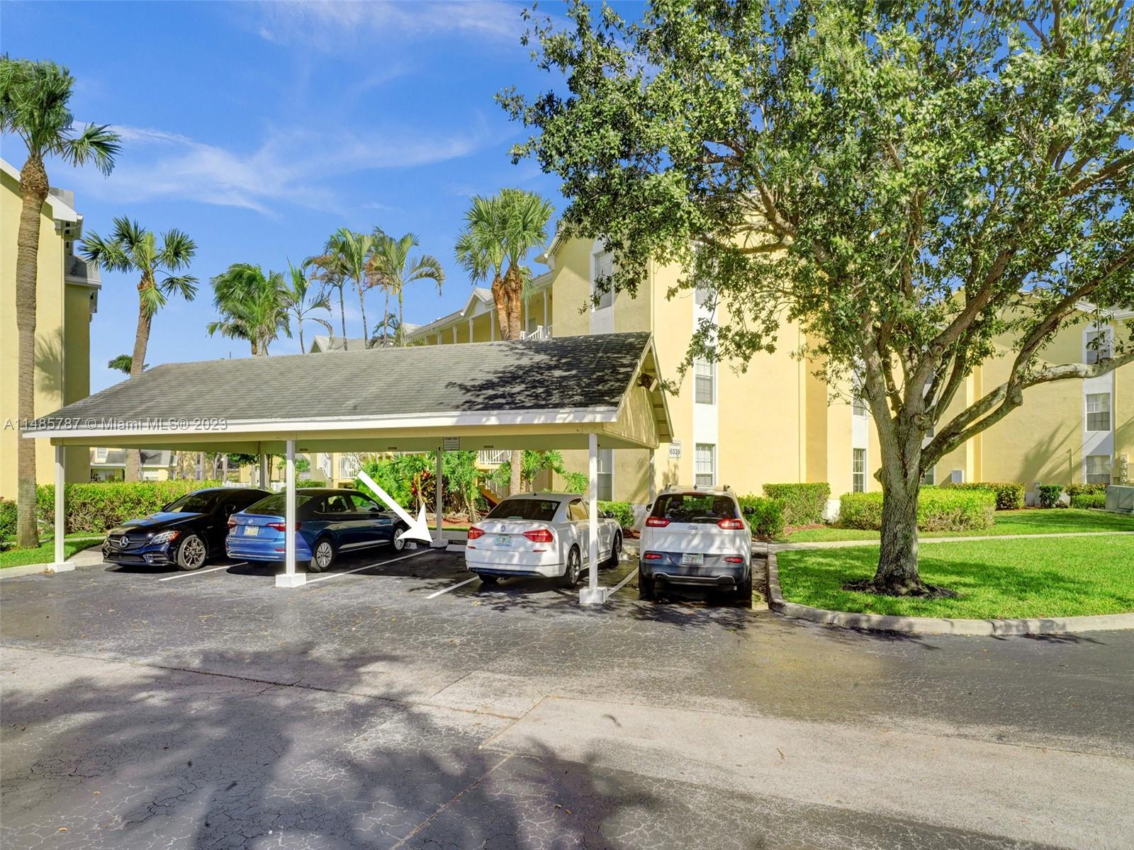 6339 La Costa Drive, Unit C Boca Raton, FL 33433 - Photo 3 of 23 a view of outdoor space with cars