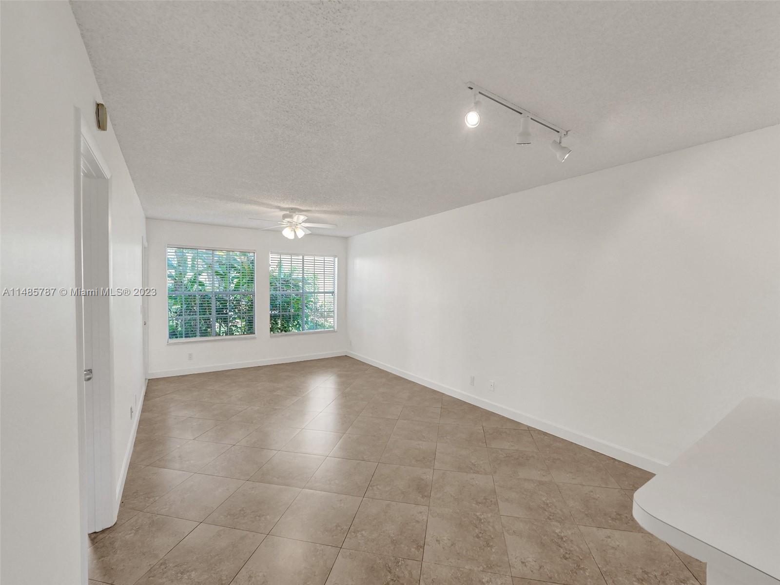 6339 La Costa Drive, Unit C Boca Raton, FL 33433 - Photo 4 of 23 wooden floor in an empty room with a window