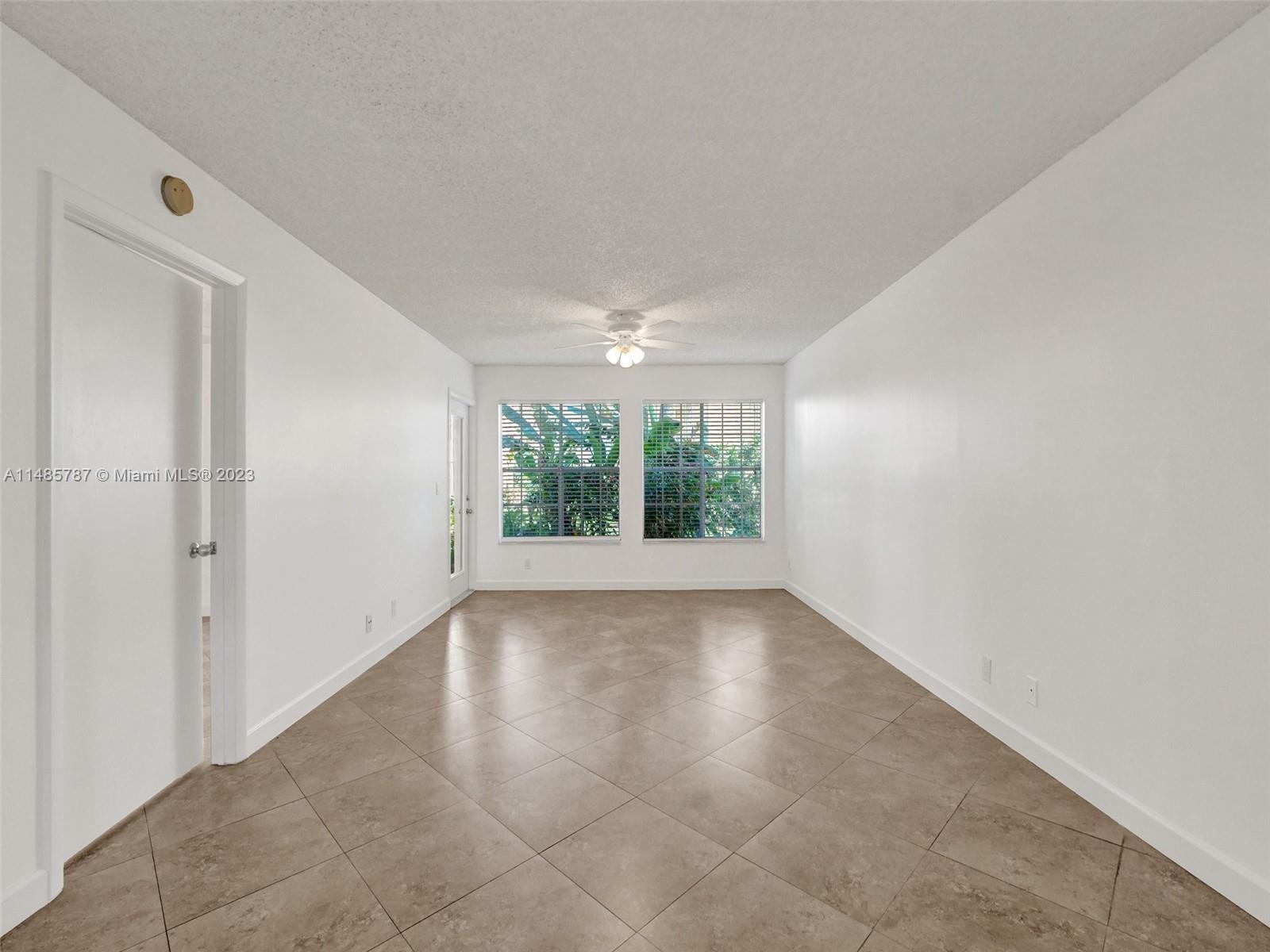 6339 La Costa Drive, Unit C Boca Raton, FL 33433 - Photo 5 of 23 wooden floor in an empty room with a window