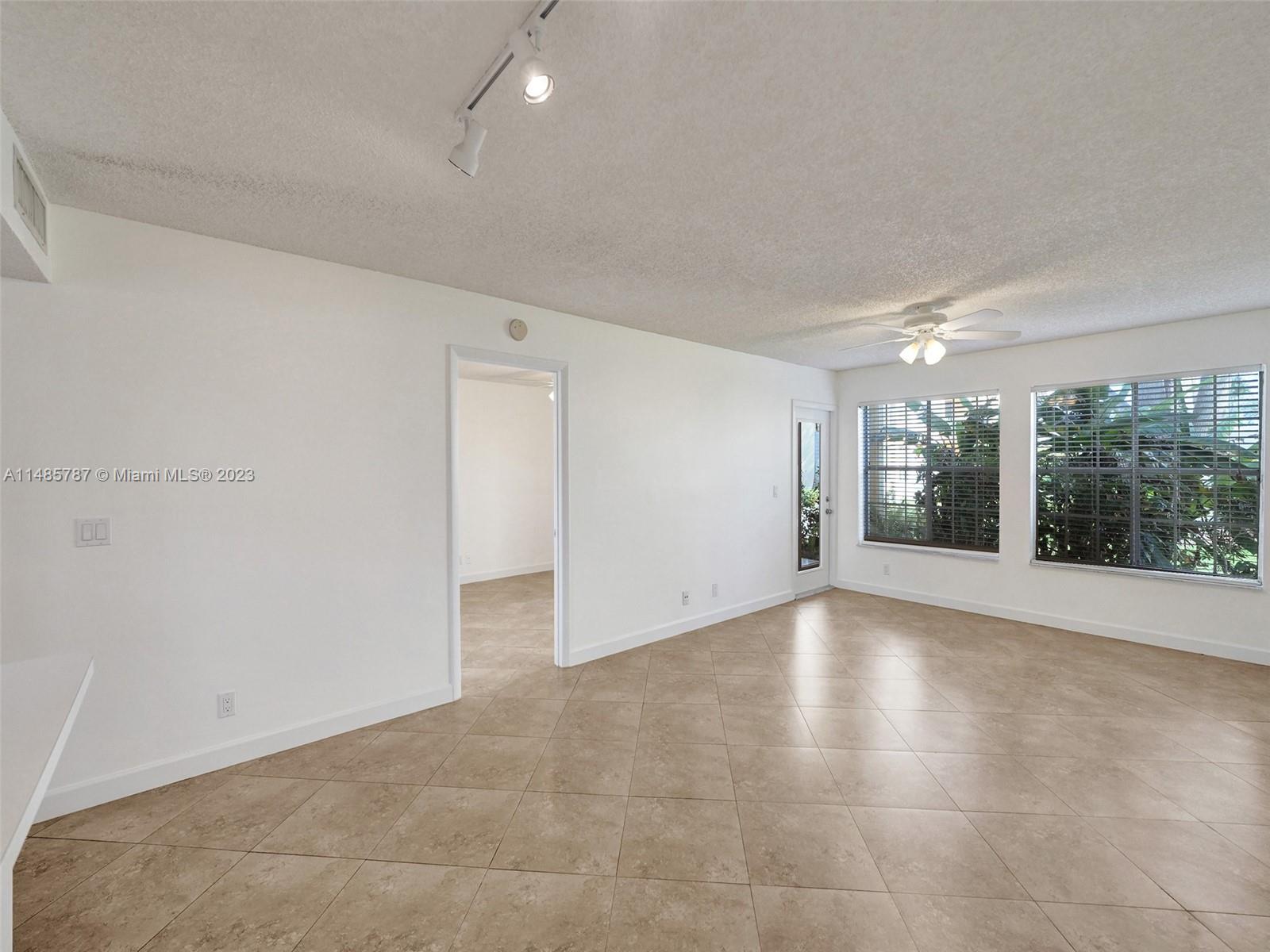 6339 La Costa Drive, Unit C Boca Raton, FL 33433 - Photo 6 of 23 wooden floor in an empty room with a window