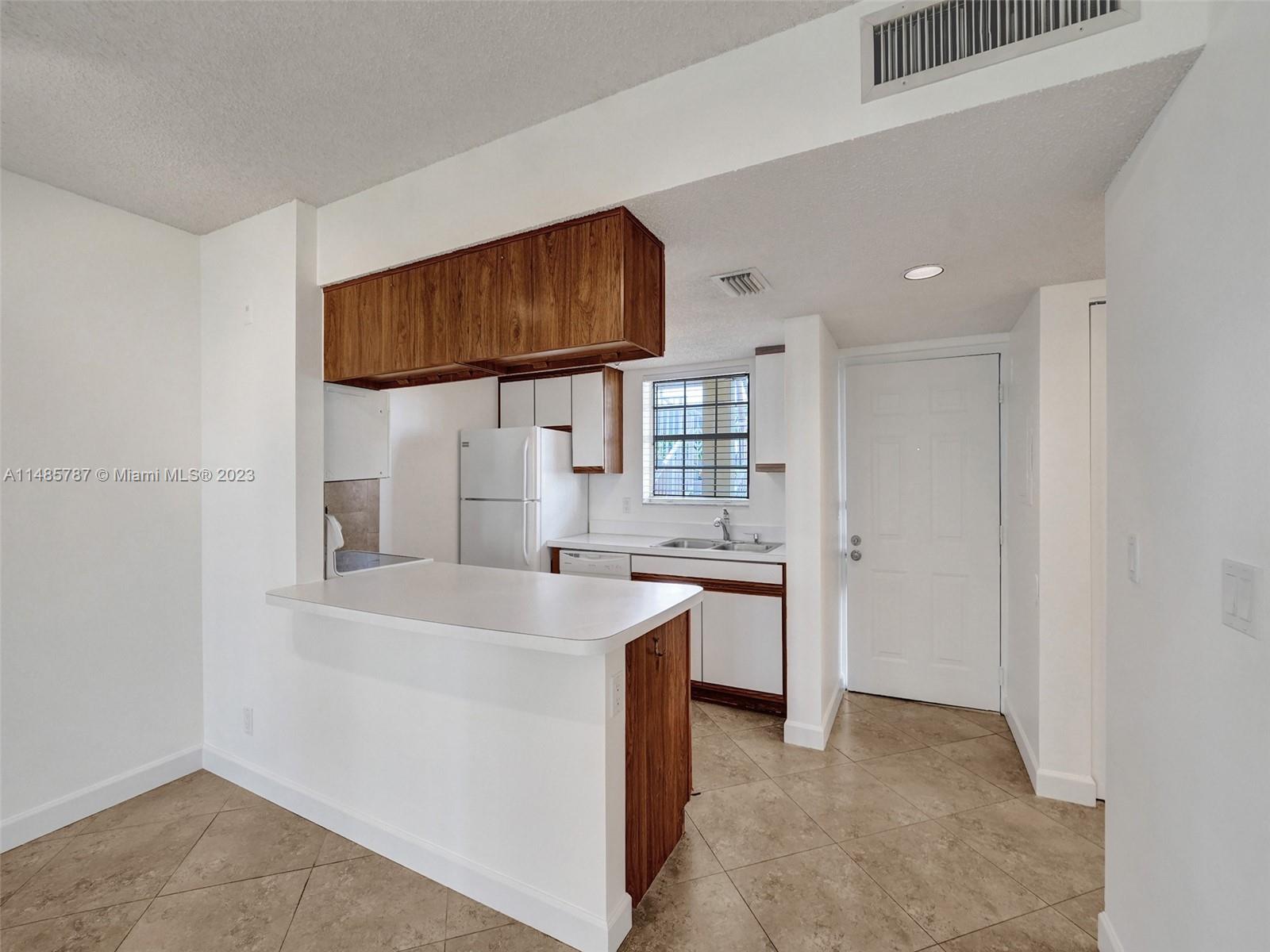 6339 La Costa Drive, Unit C Boca Raton, FL 33433 - Photo 9 of 23 a kitchen with stainless steel appliances a sink stove and cabinets