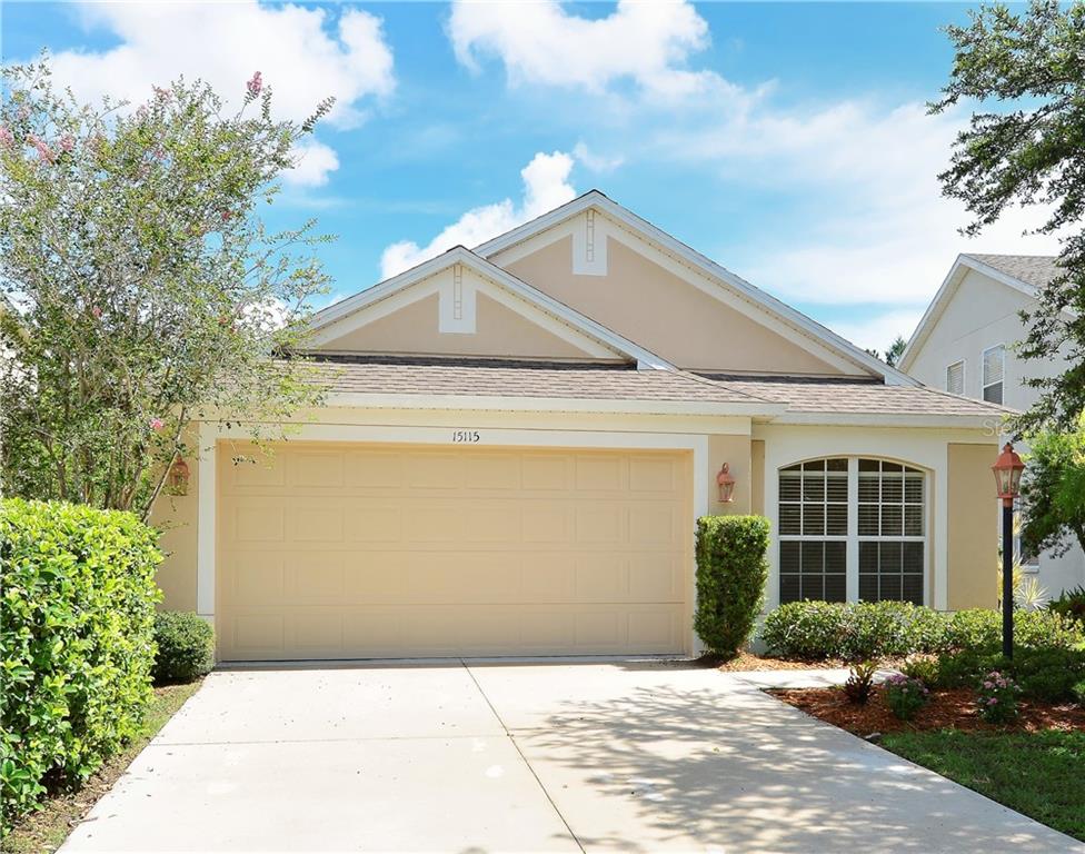 15115 Skip Jack Loop Lakewood Ranch, FL 34202 - Photo 1 of 1 a front view of a house with a yard and potted plants
