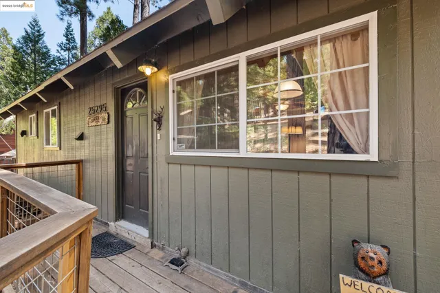 a view of a house with backyard and wooden floor