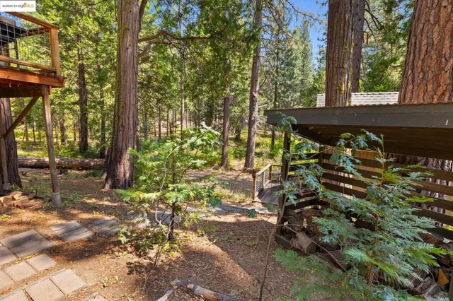 a view of a patio with table and chairs with wooden floor and fence
