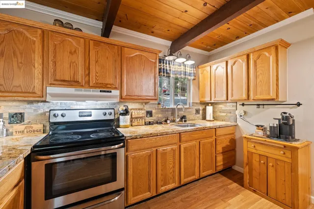 a kitchen with stainless steel appliances a stove sink and cabinets