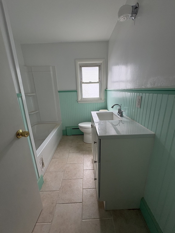 764 Hancock Street, Unit 2 Quincy, MA 02170 - Photo 5 of 6 a bathroom with a sink a toilet and a mirror