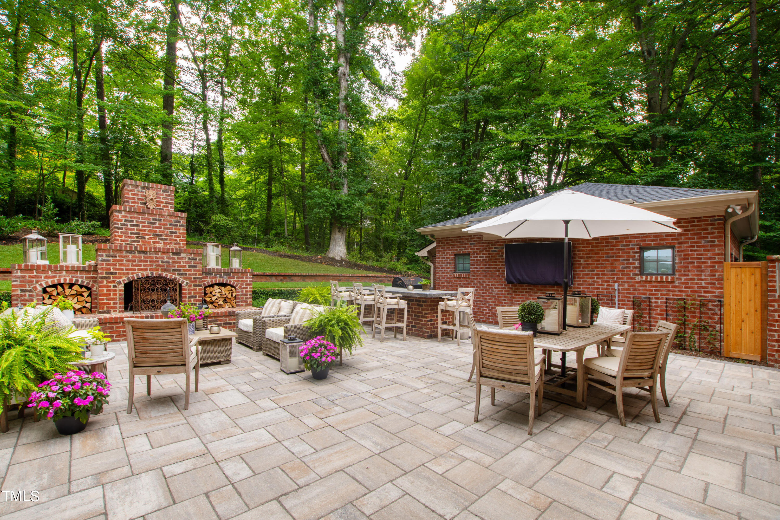 612 Marlowe Road Raleigh, NC 27609 - Photo 14 of 60 a view of a patio with a dining table and chairs under an umbrella