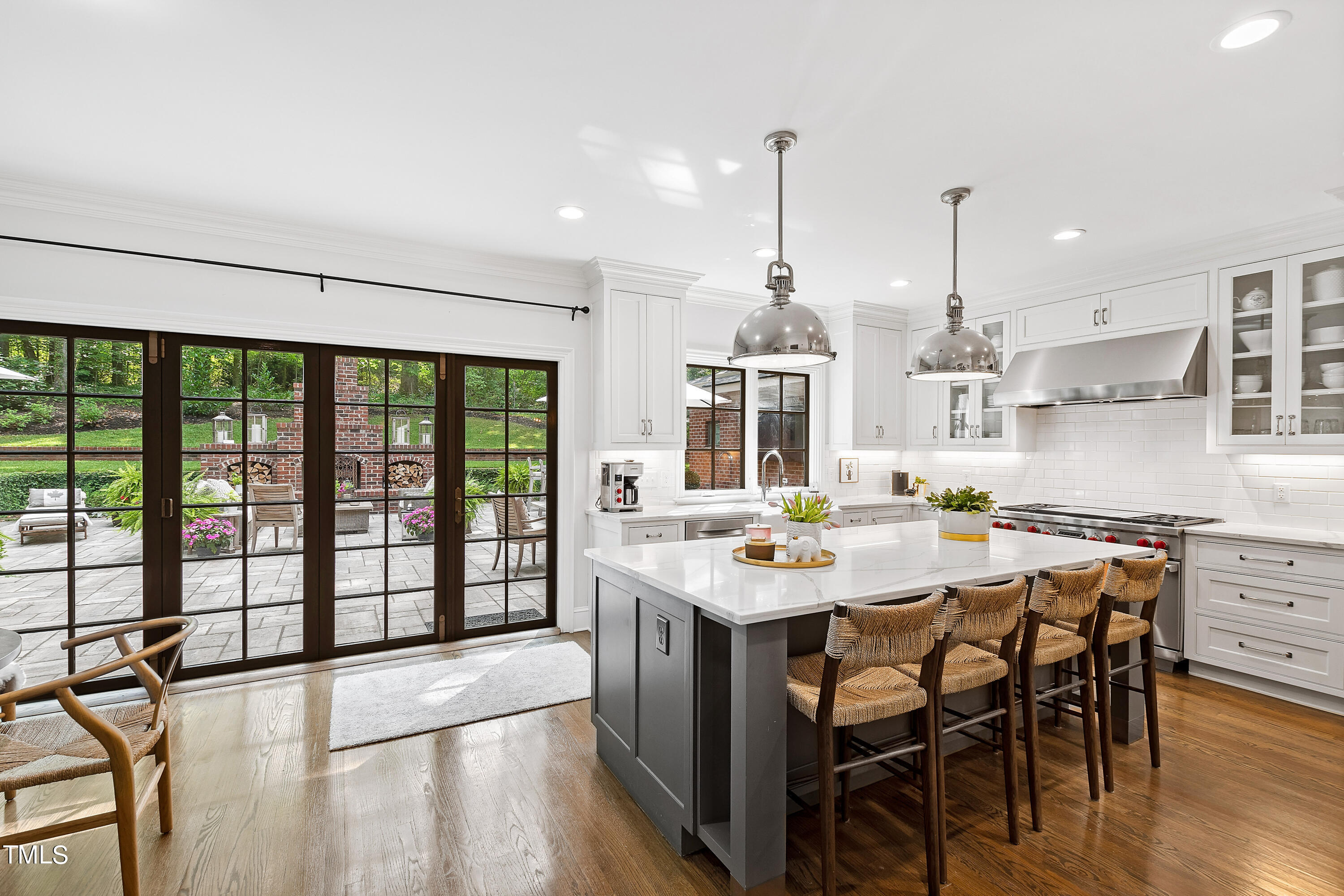 612 Marlowe Road Raleigh, NC 27609 - Photo 48 of 60 a kitchen with stainless steel appliances granite countertop a stove a kitchen island a table and chairs with wooden floor