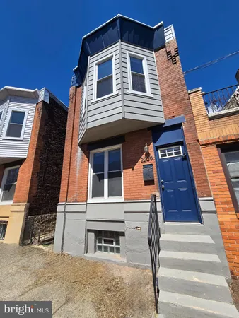 a front view of a house with wooden stairs