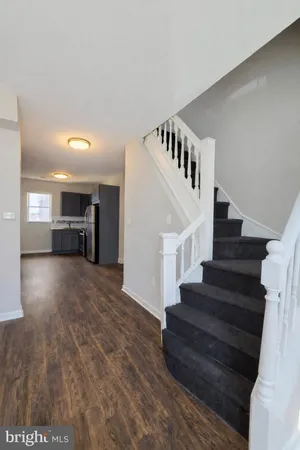 a view of entryway and hall with wooden floor
