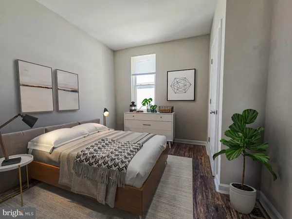 a bedroom with a large bed and a potted plant