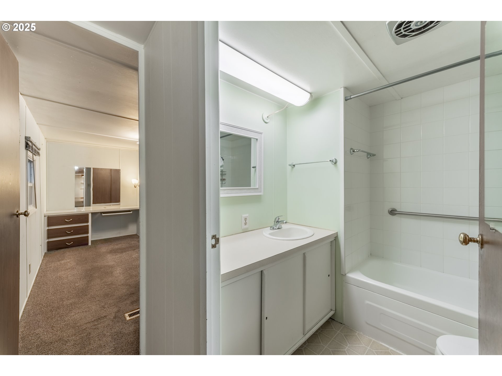 3500 Southeast Concord Road, Unit 65 Milwaukie, OR 97267 - Photo 12 of 19 a bathroom with a tub sink and a mirror