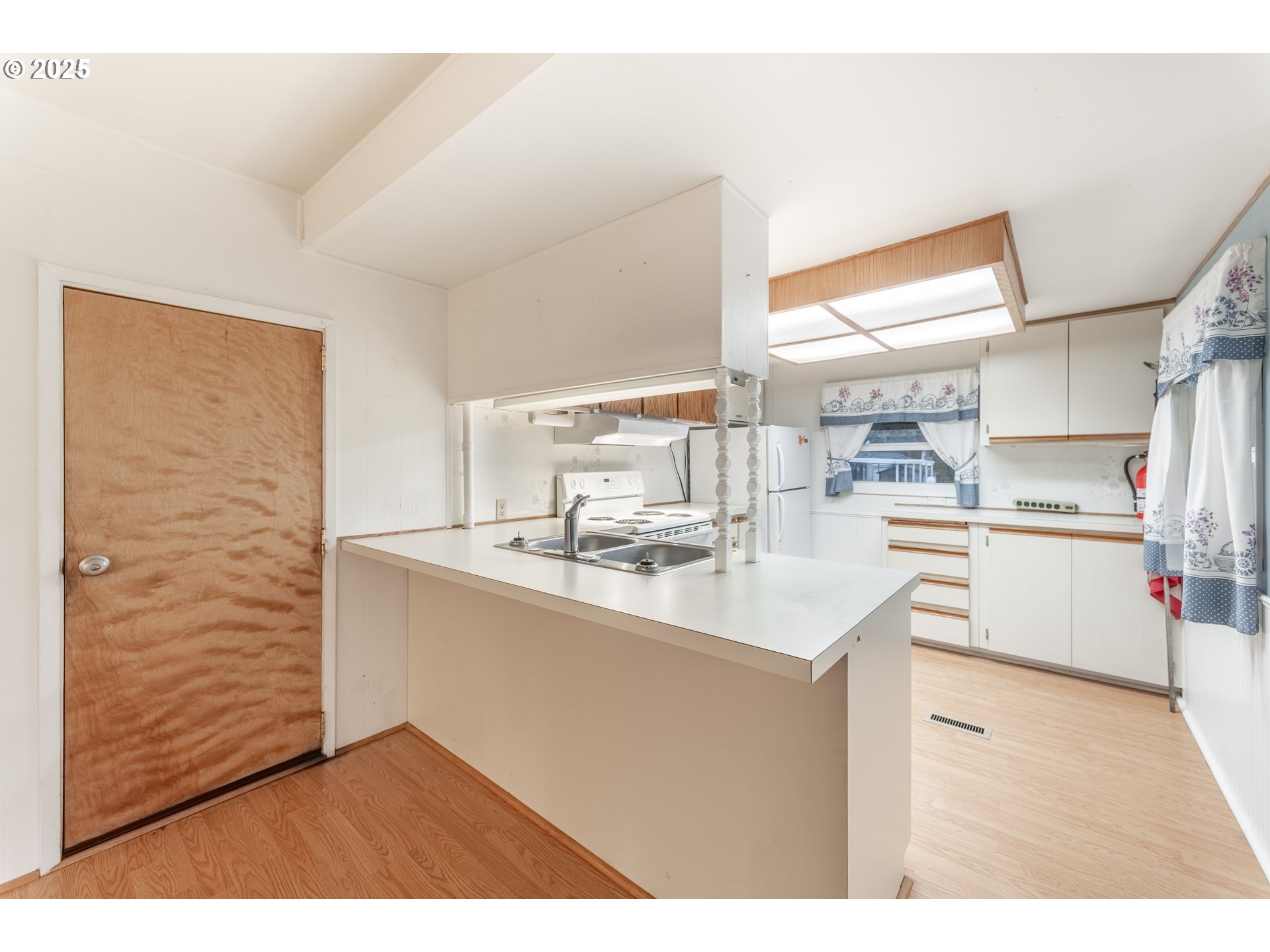 3500 Southeast Concord Road, Unit 65 Milwaukie, OR 97267 - Photo 2 of 19 a kitchen with stainless steel appliances a sink a stove a refrigerator and cabinets