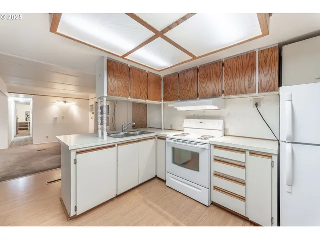 a kitchen with granite countertop a sink stainless steel appliances and cabinets