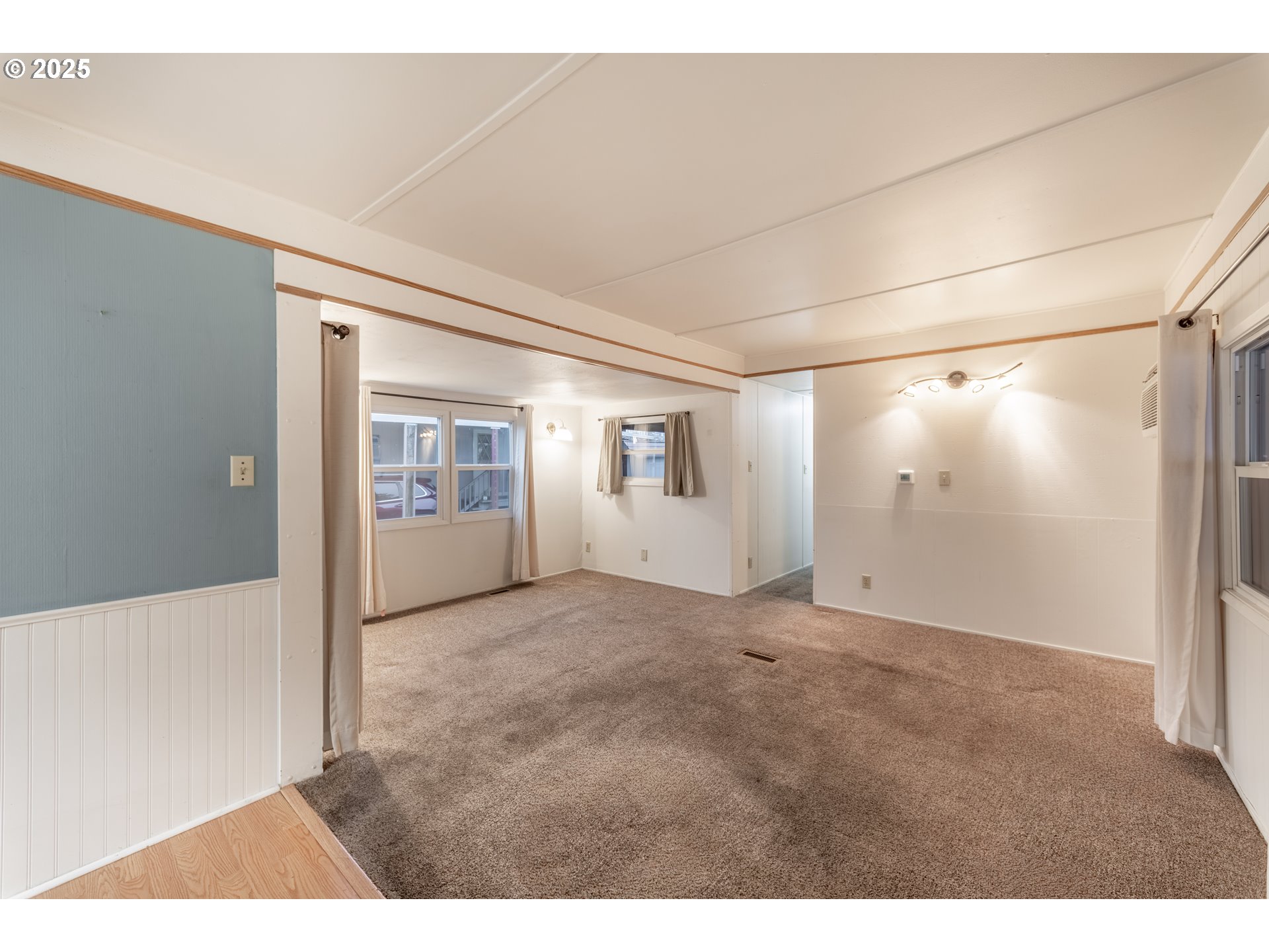 3500 Southeast Concord Road, Unit 65 Milwaukie, OR 97267 - Photo 5 of 19 a view of a big room with wooden floor and windows