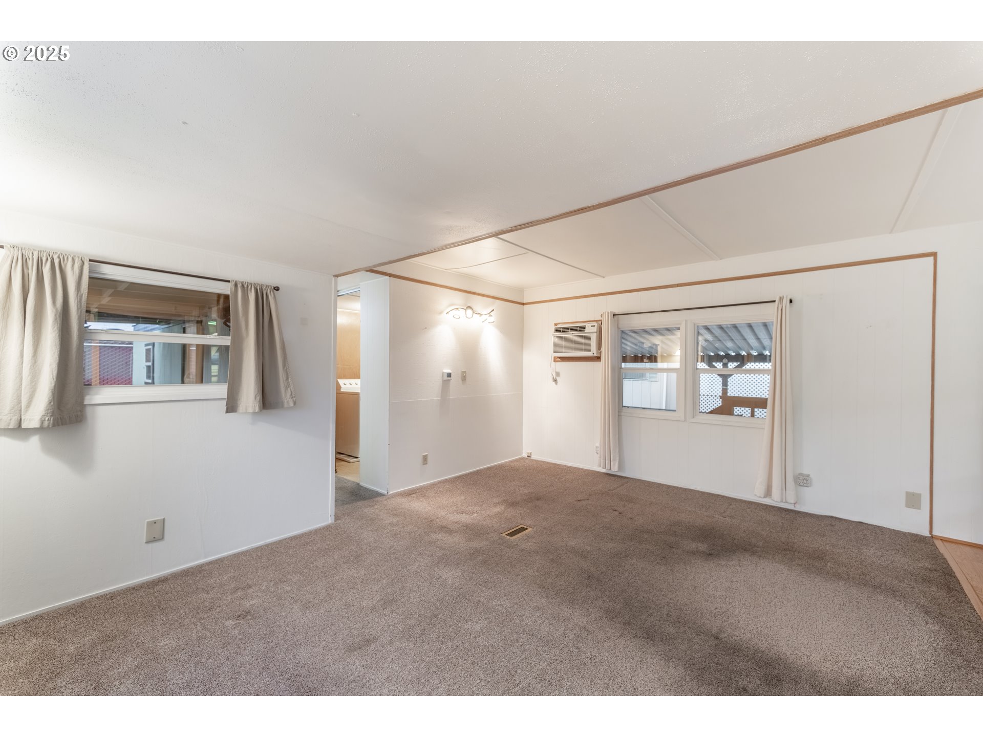 3500 Southeast Concord Road, Unit 65 Milwaukie, OR 97267 - Photo 6 of 19 a view of a big room with wooden floor and windows