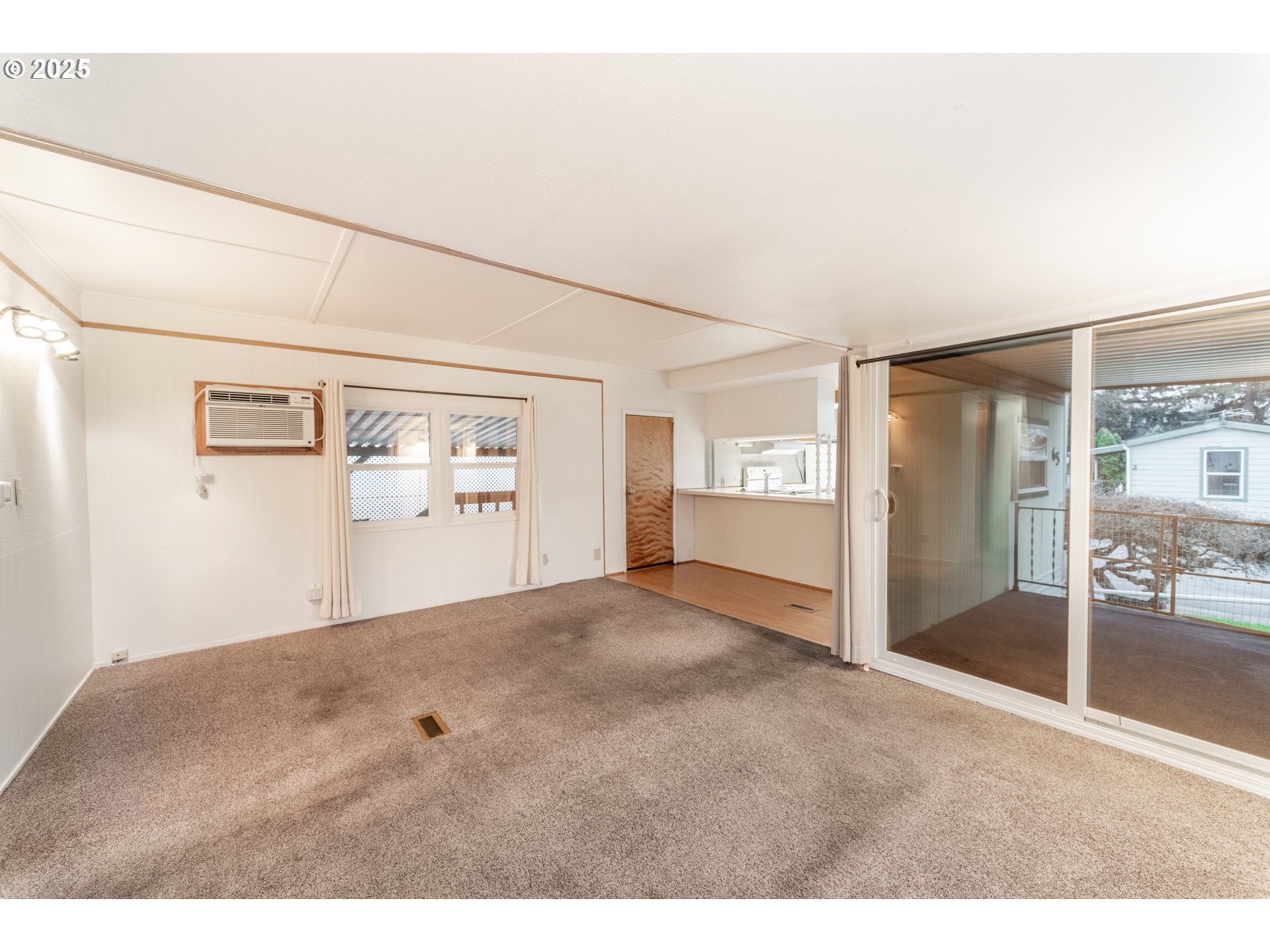 3500 Southeast Concord Road, Unit 65 Milwaukie, OR 97267 - Photo 8 of 19 a view of a big room with wooden floor and windows
