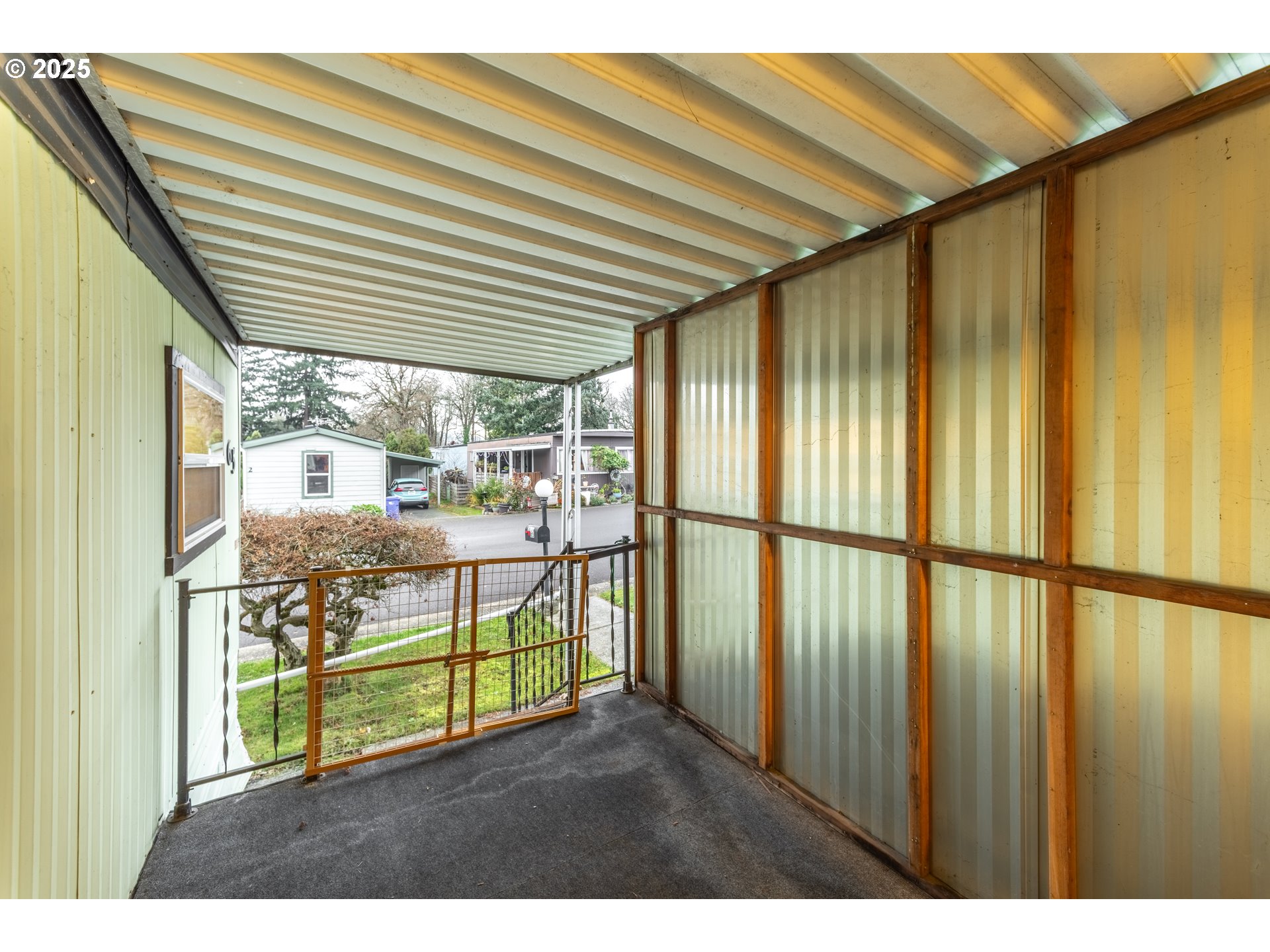 3500 Southeast Concord Road, Unit 65 Milwaukie, OR 97267 - Photo 9 of 19 a view of a porch with a table and chairs