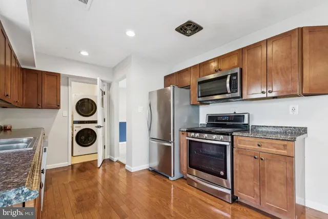 a kitchen with stainless steel appliances granite countertop a stove and a microwave