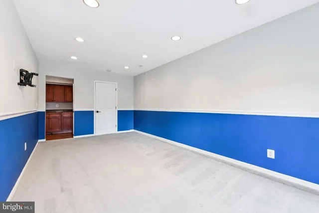 a view of an empty room with a kitchen