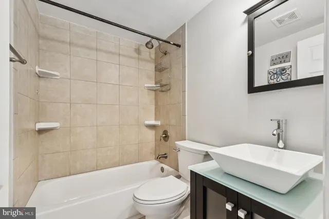 a bathroom with a sink a toilet and a bathtub